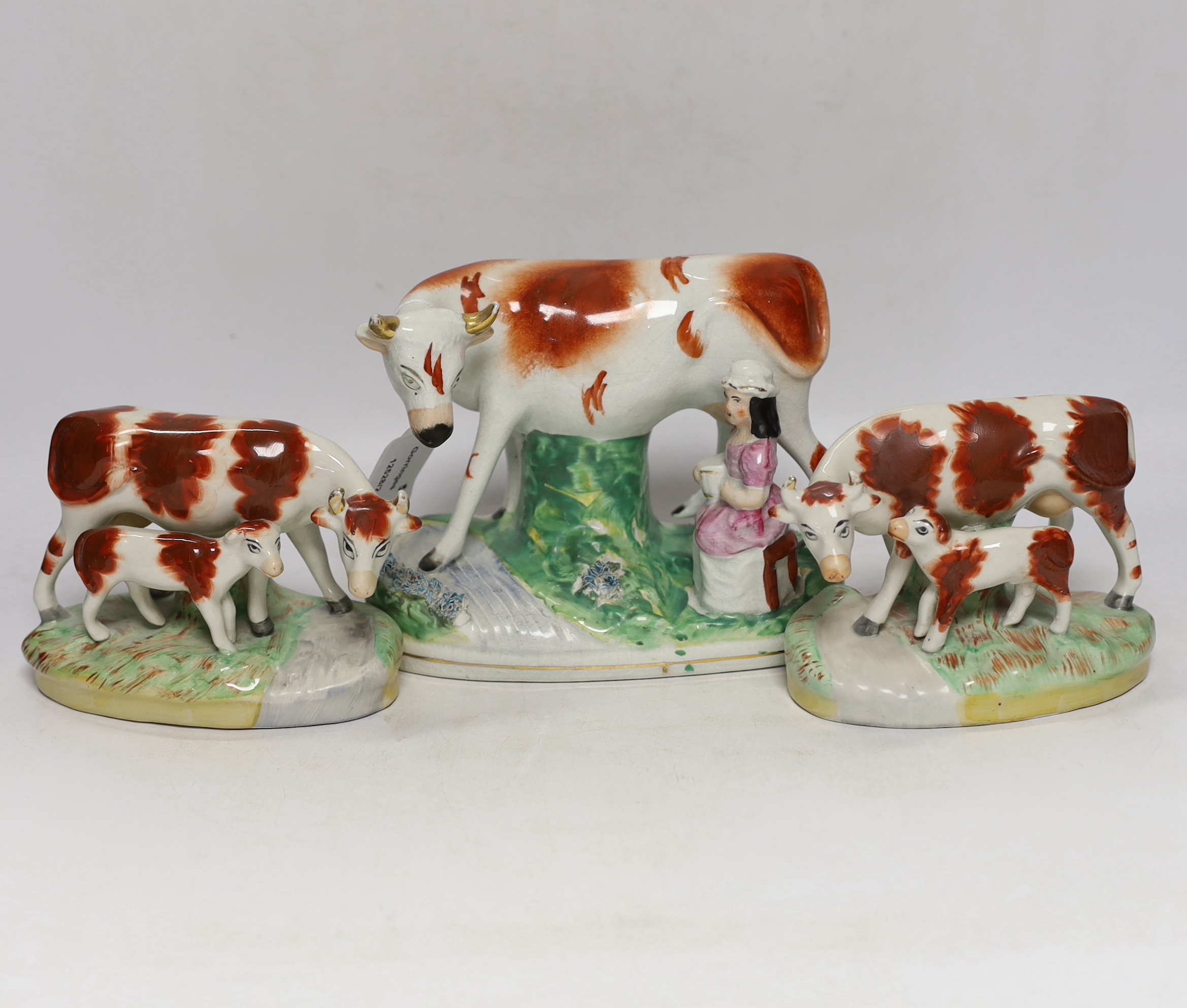 Three Victorian Staffordshire cow groups, tallest 15cm high